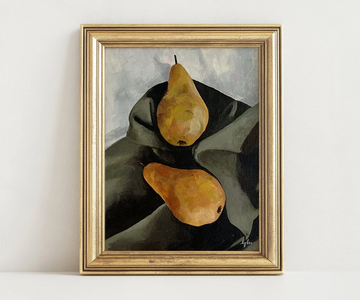 gold framed painting of two yellow pears on green sheet