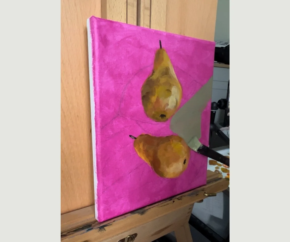 painting in progress of two pears on easel with bright pink background