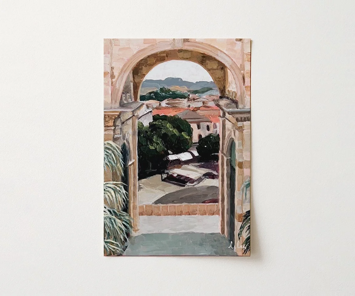 print of archway painting sitting on table