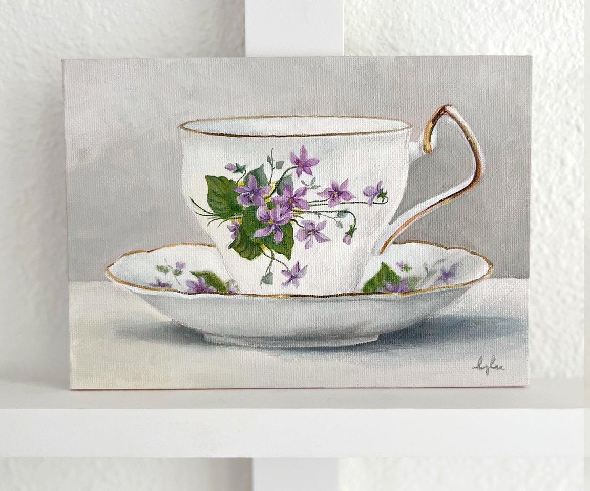 painting of teacup and saucer with bouquet of violets against white wall