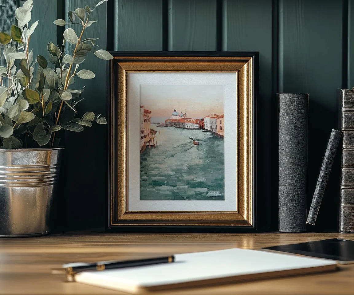 framed print of grand canal painting on desk
