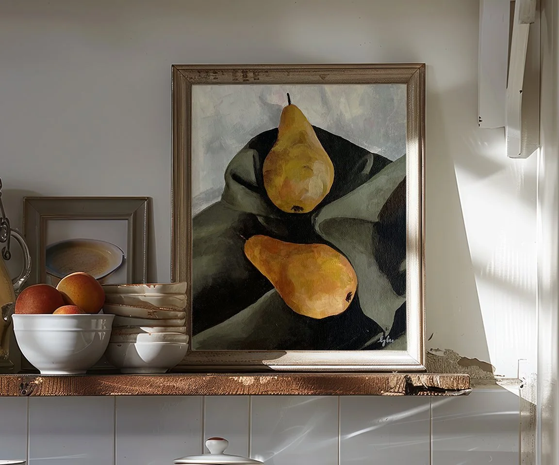 framed painting of two yellow pears on green sheet sitting on kitchen shelf