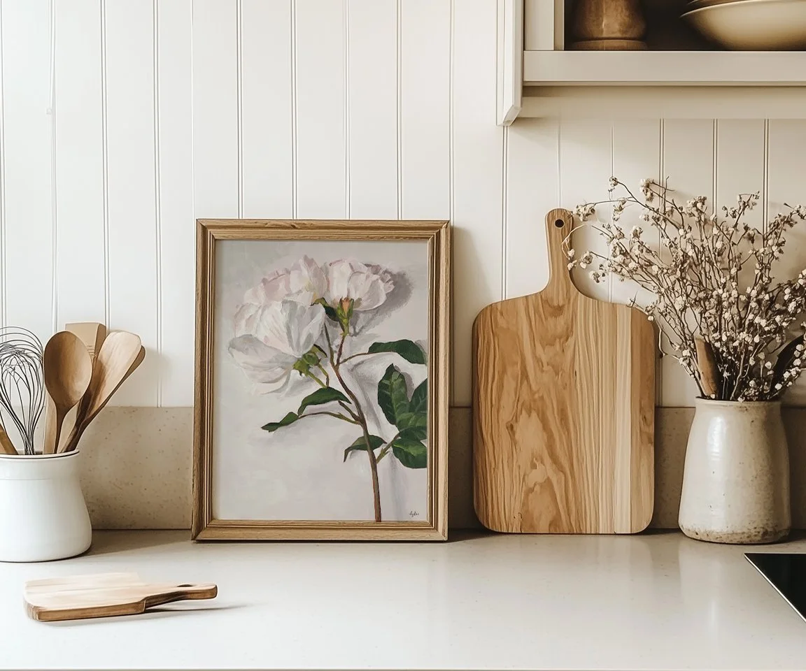 Framed painting of roses on kitchen counter