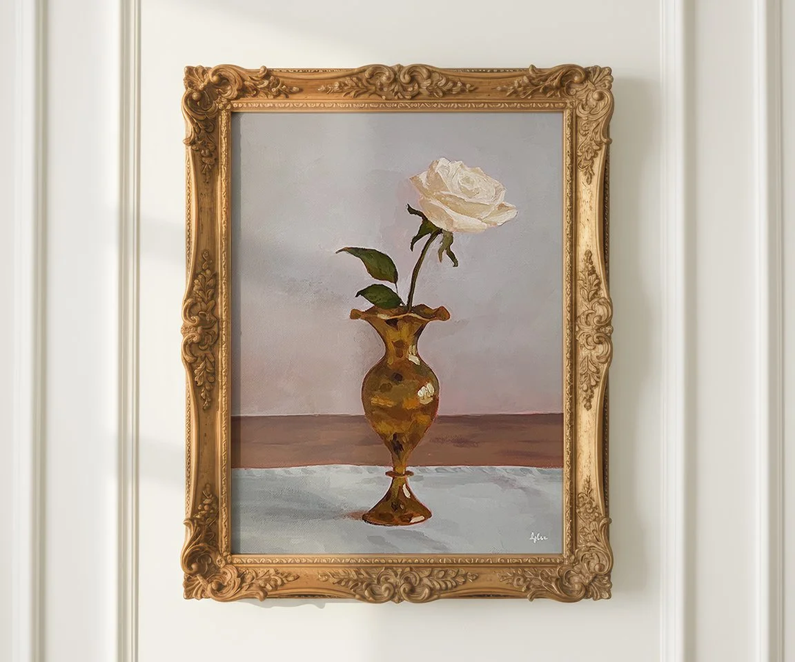 gold framed painting of white rose in brass bud vase