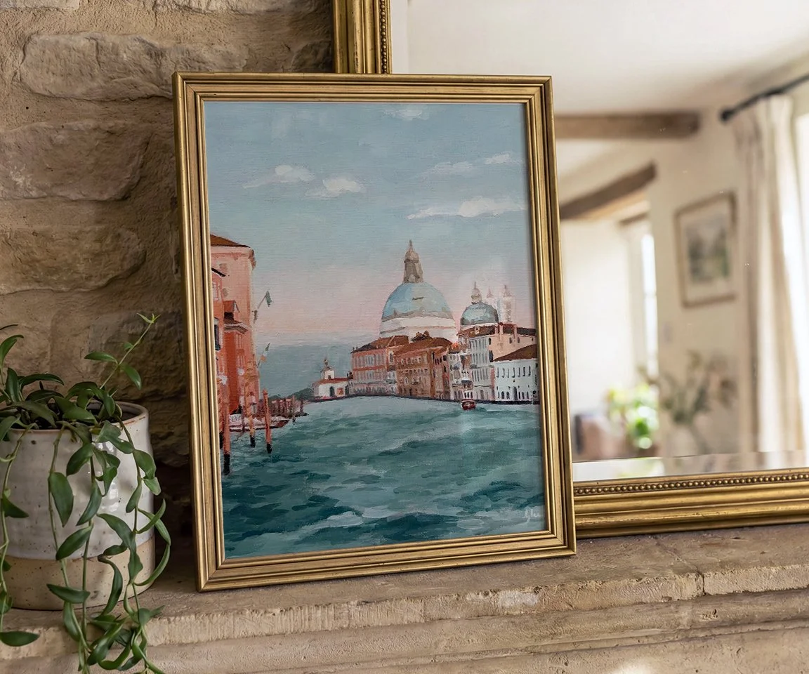 gold framed painting on mantle with mirror