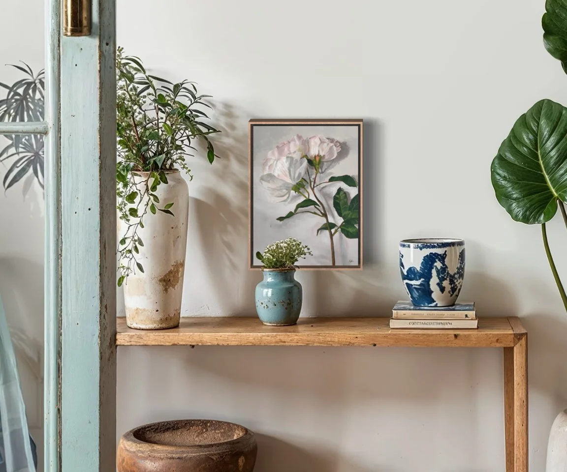 framed painting of roses with garden supplies