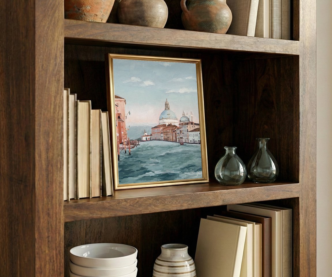 framed print of painting on bookshelf