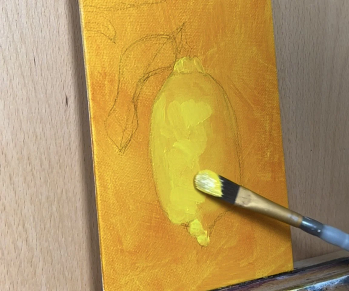 canvas on easel with lemon painting in progress