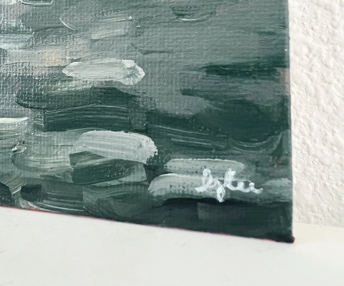 detail image of artist signature on green