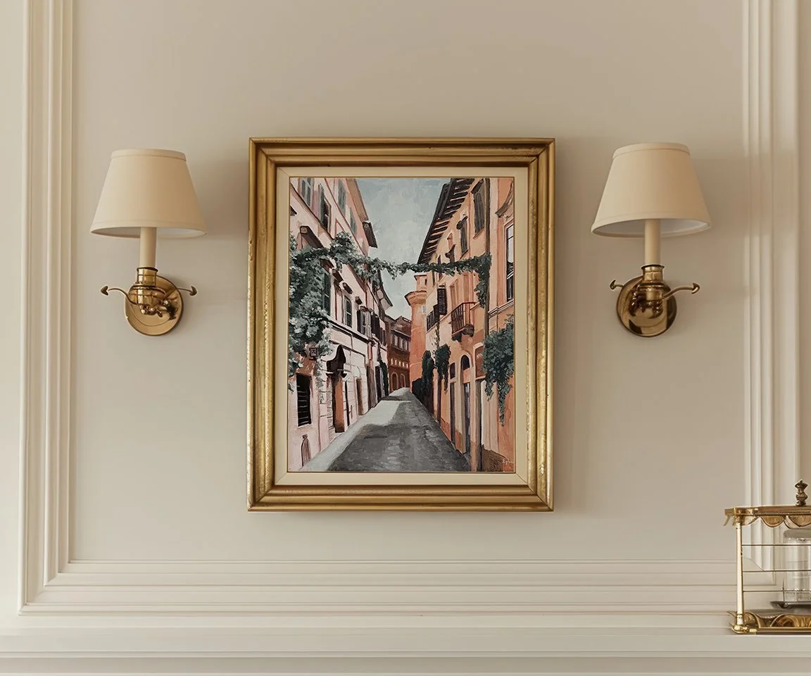 gold framed painting of alleyway in Rome with sconces