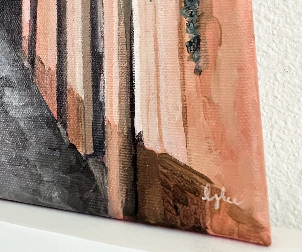 detail image of artist signature on orange