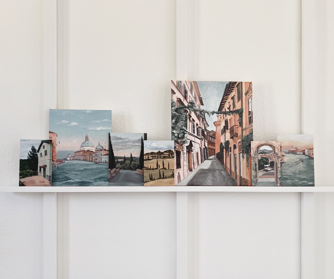 seven Italian landscape paintings on shelf