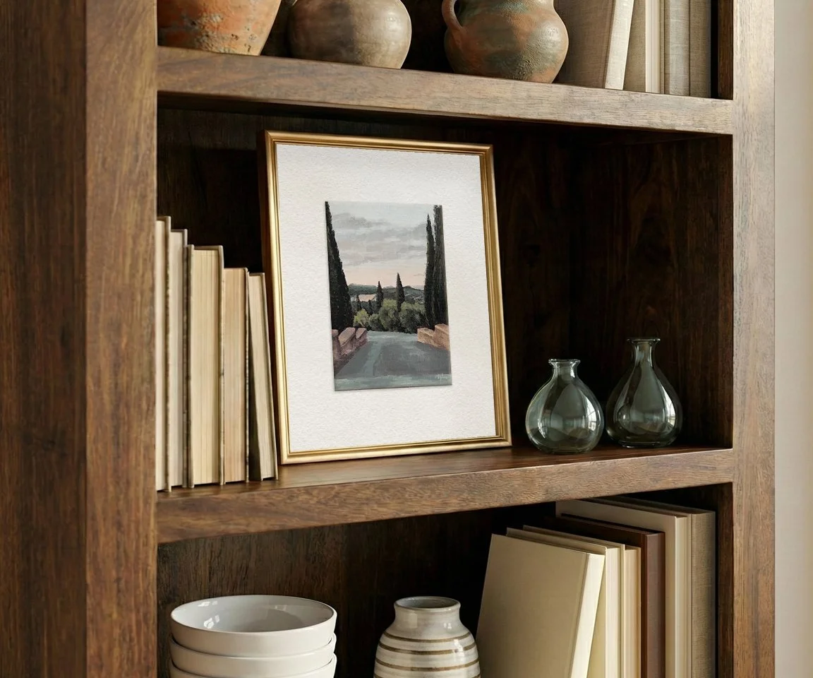 oversized frame of dusk over Tuscany painting on bookshelf