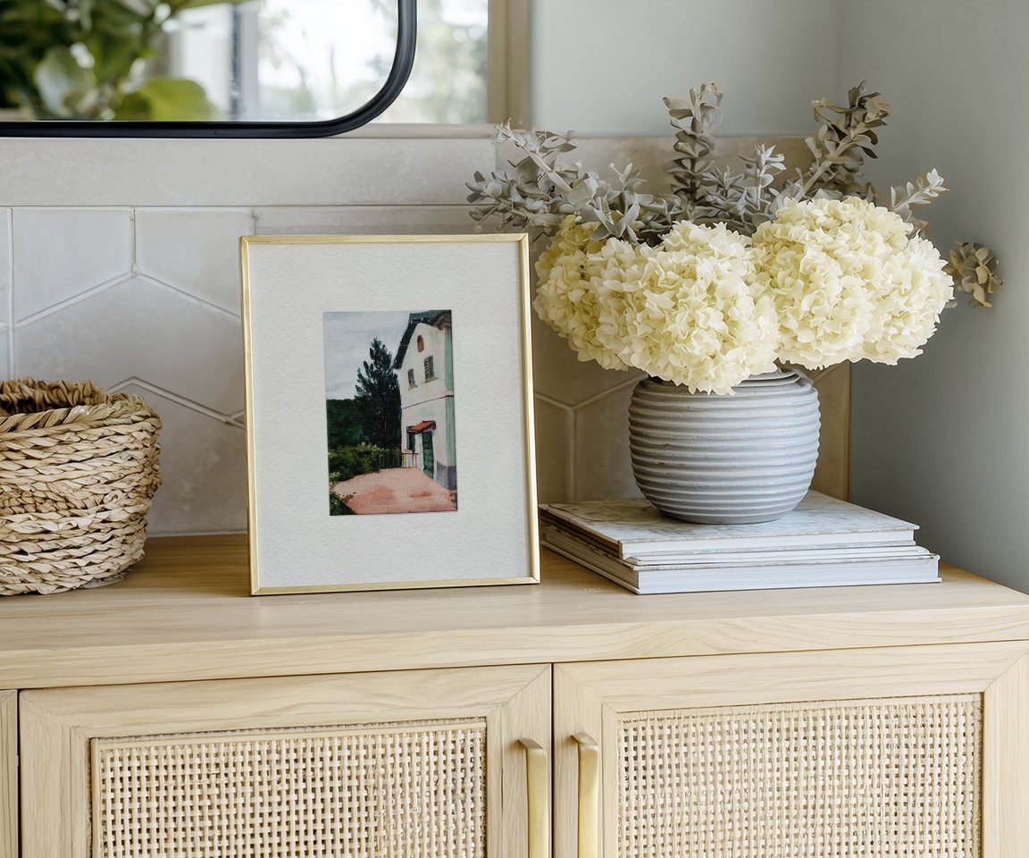 framed painting of Italian villa on entryway credenza