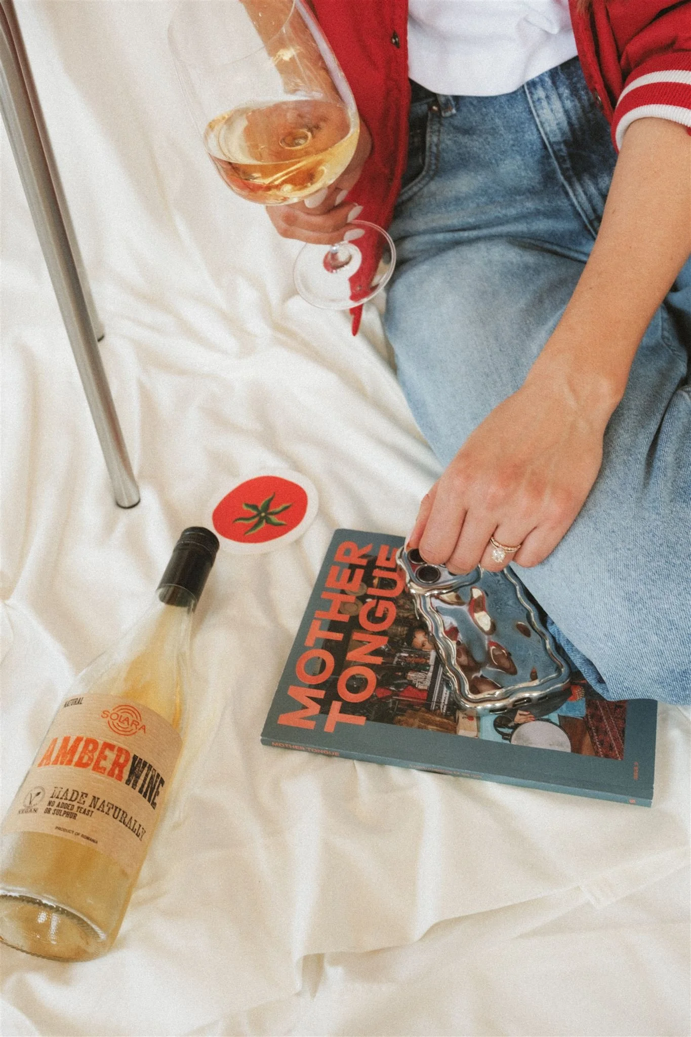  A brand photoshoot with wine, a book, and a phone. 