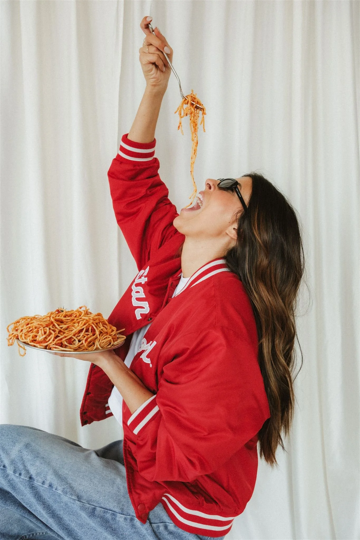  A business owner eating spaghetti as a unique brand photoshoot prop. 