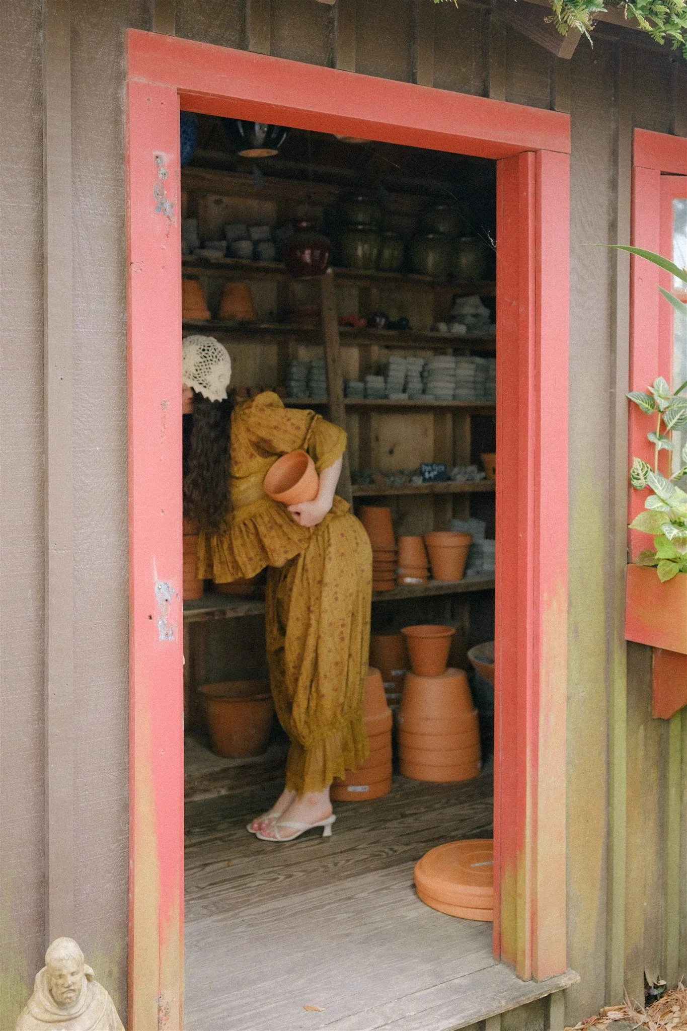  A woman holding a flower pot. 