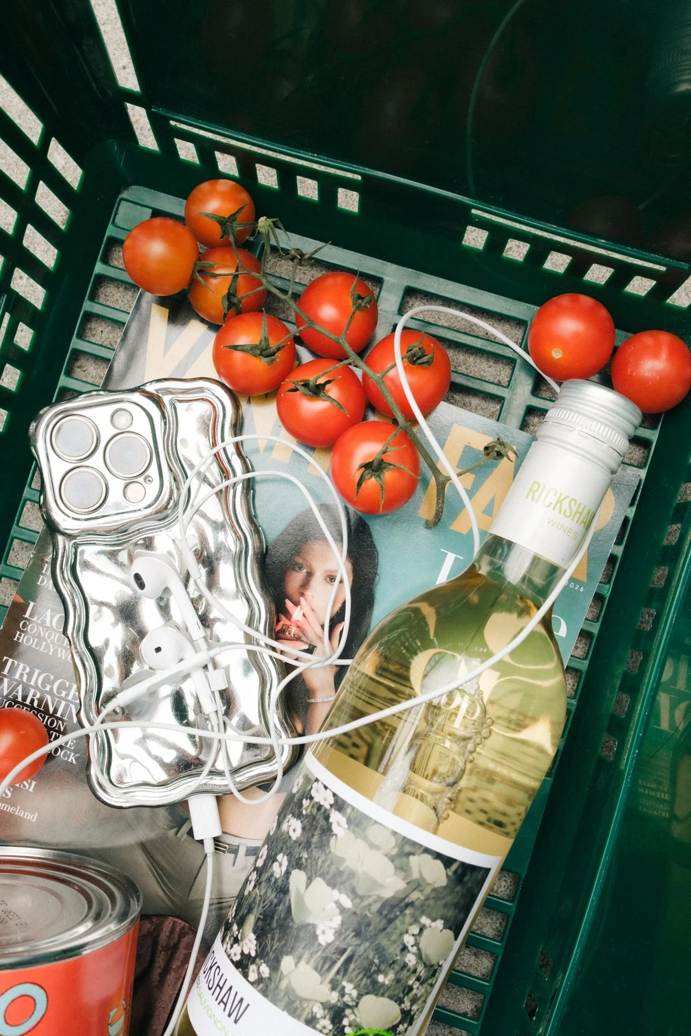  Unique photoshoot prop ideas of a magazine, tomatoes, wine, and headphones.  