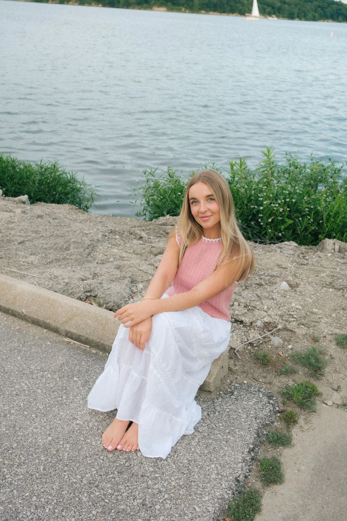 A woman sitting by the water in Kansas City for brand photos.