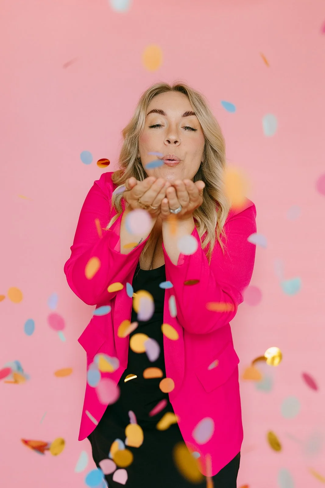 A Kansas City business owner blowing confetti.