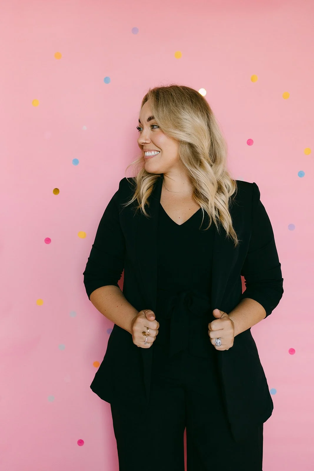  A woman holding her jacket and looking to the side for business headshots. 