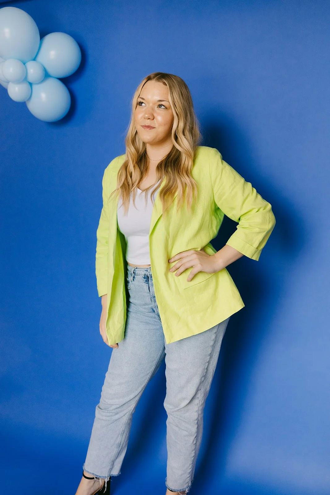  A woman looking off into the distance while posing for business headshots. 