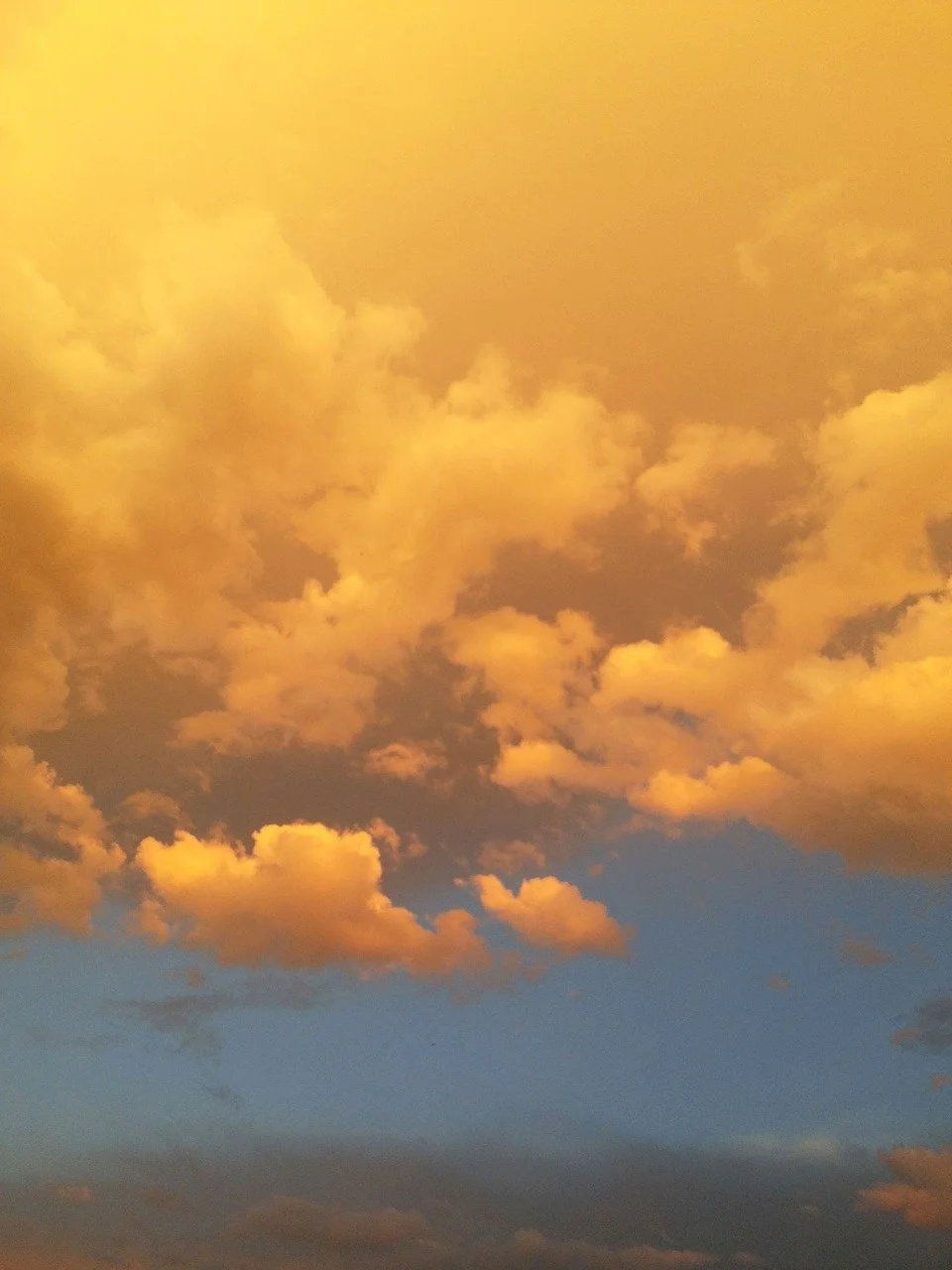 Sky with orange-tinted clouds during sunset or sunrise.