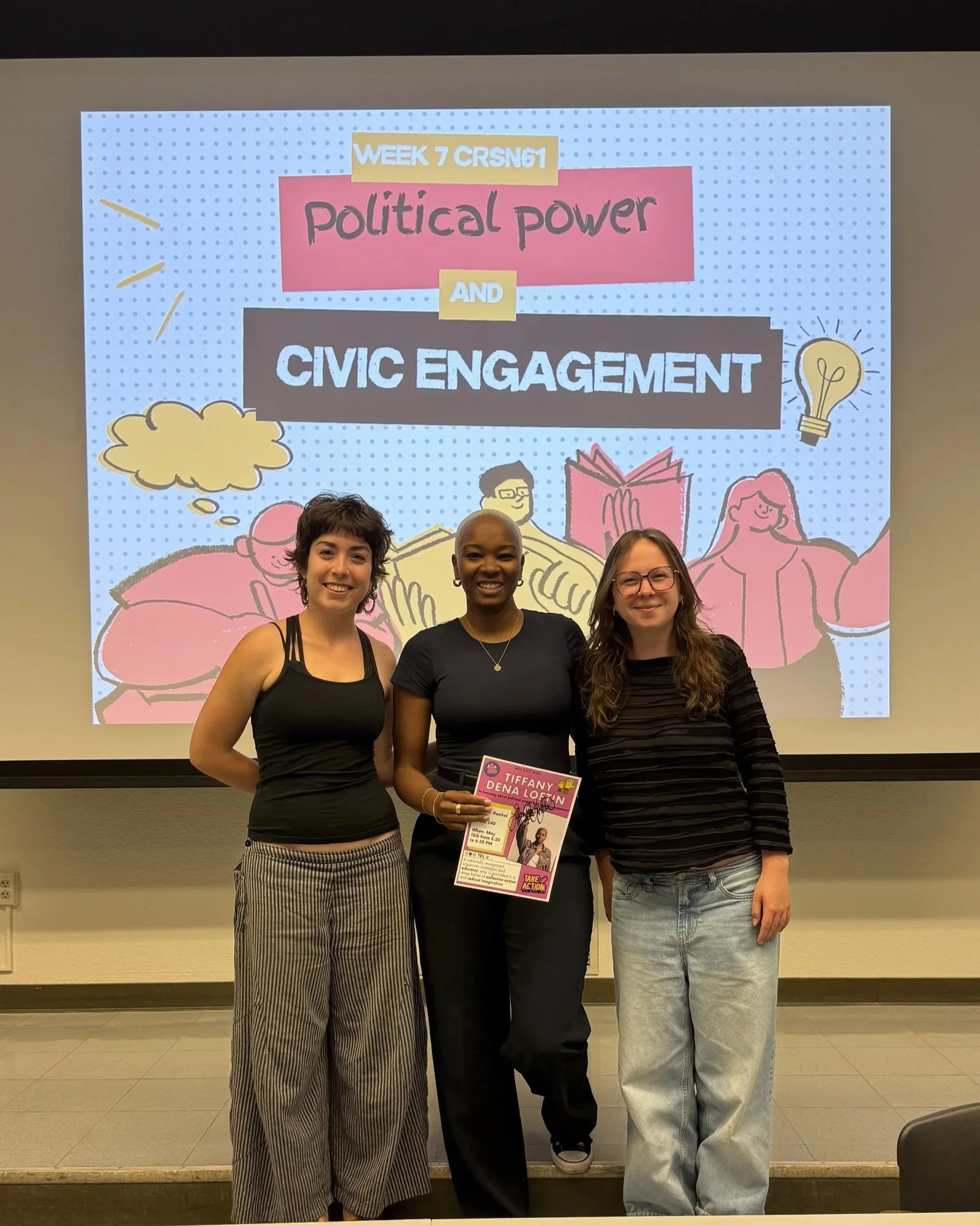 Three women standing in front of a presentation screen that displays the text 'Week 7 Crsn61: Political Power and Civic Engagement.' The woman in the middle is holding a flyer and the woman on the right is wearing glasses and smiling. The background features cartoon illustrations of people and lightbulbs.