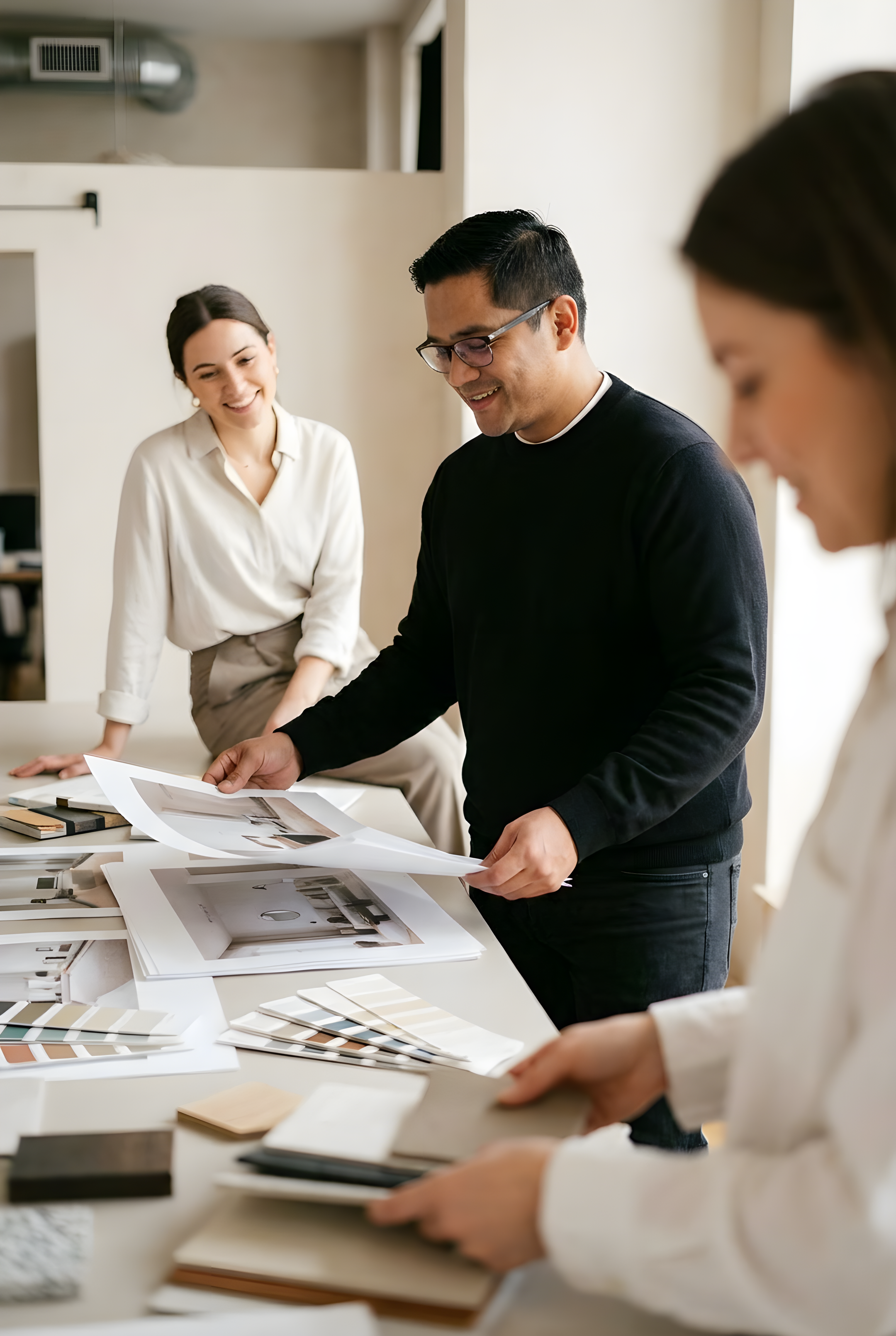 Exhibition design team reviewing material samples and booth concepts for brand activation and experiential marketing project
