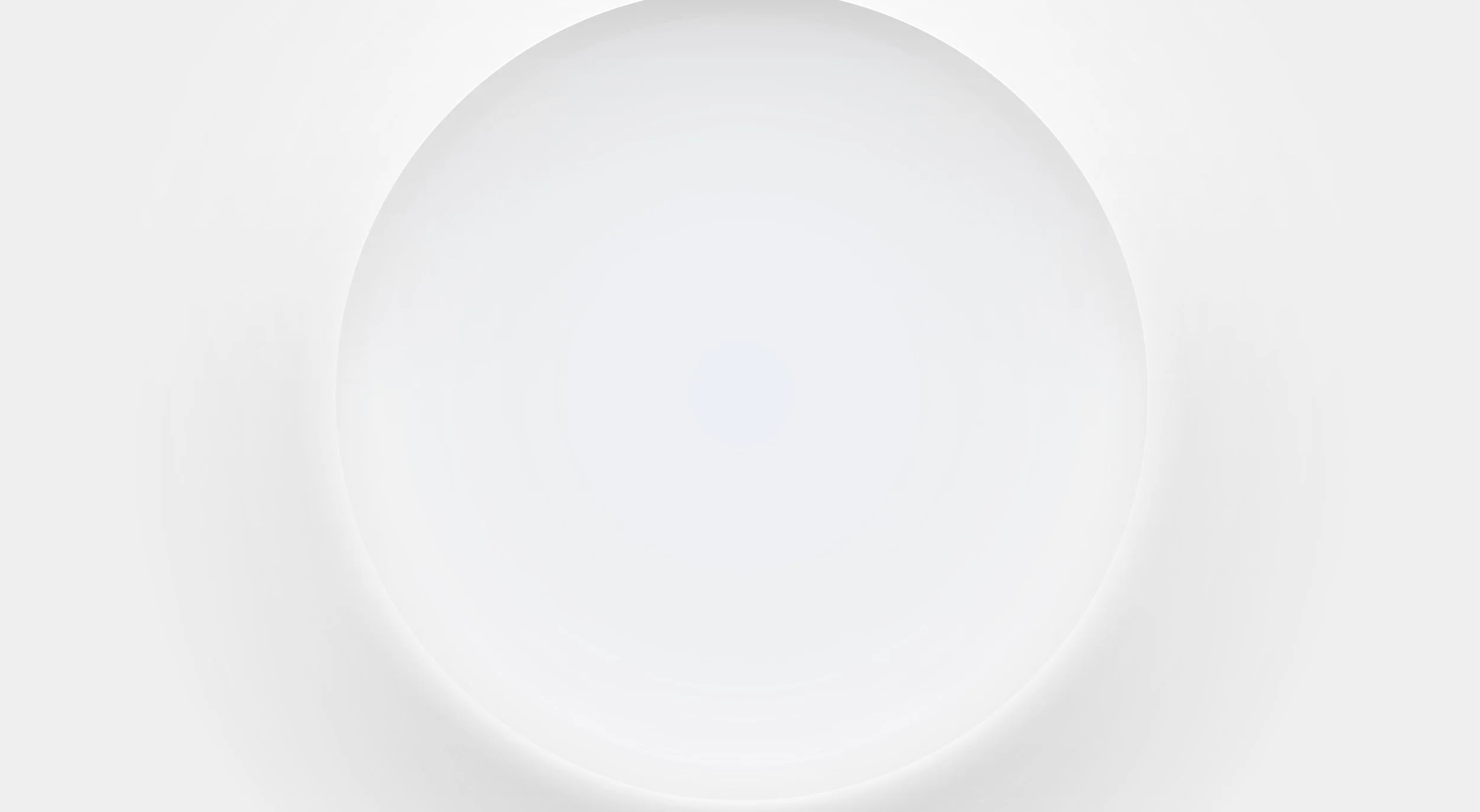 A blank, white, circular surface with subtle shading and shadows, resembling a light bulb