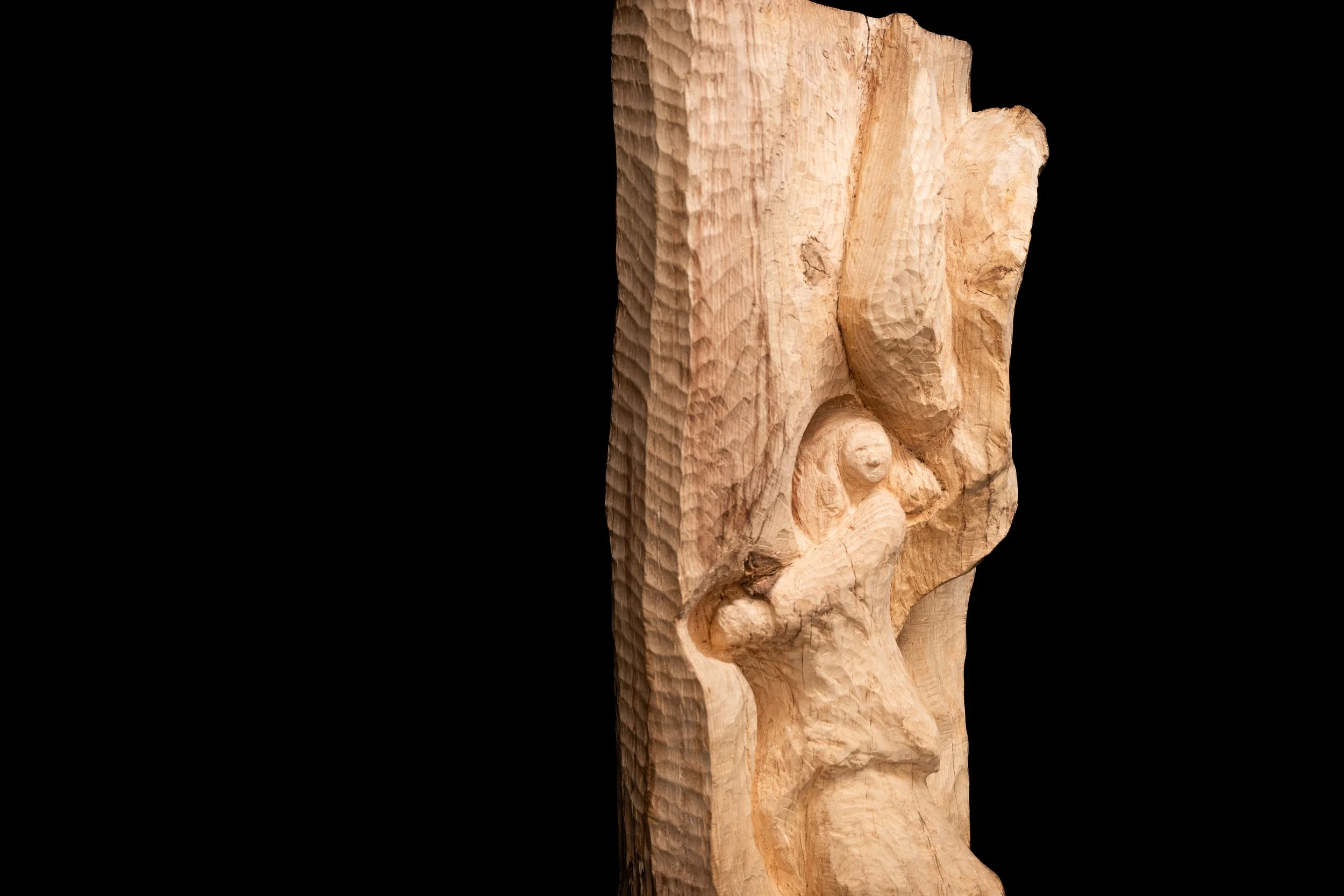 Angel embraces the Oak Log of which she is carved from by David Puustinen.