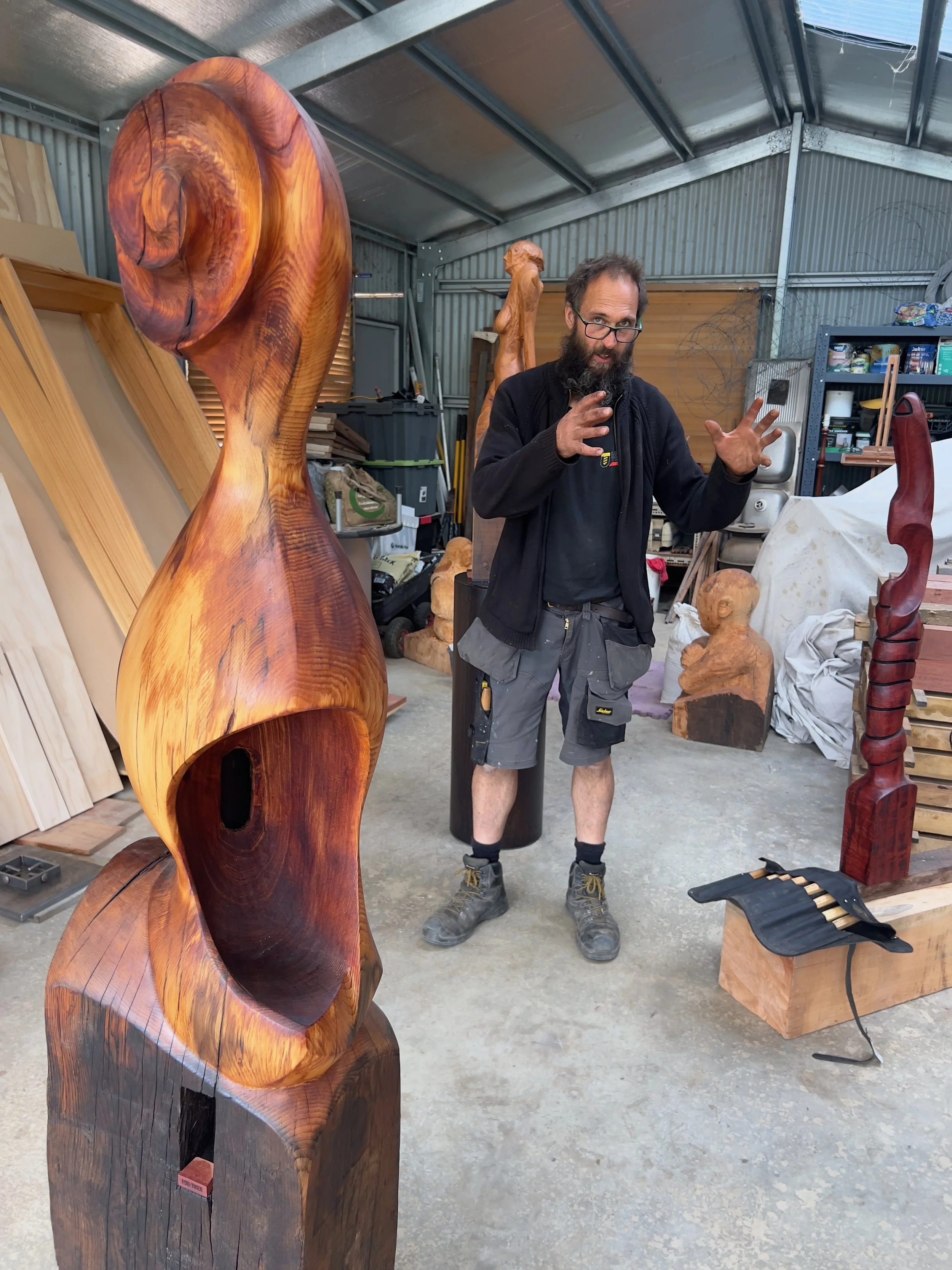 David Puustinen in studio amongst his sculptures. Sculpture in front is ’Sound Shell'