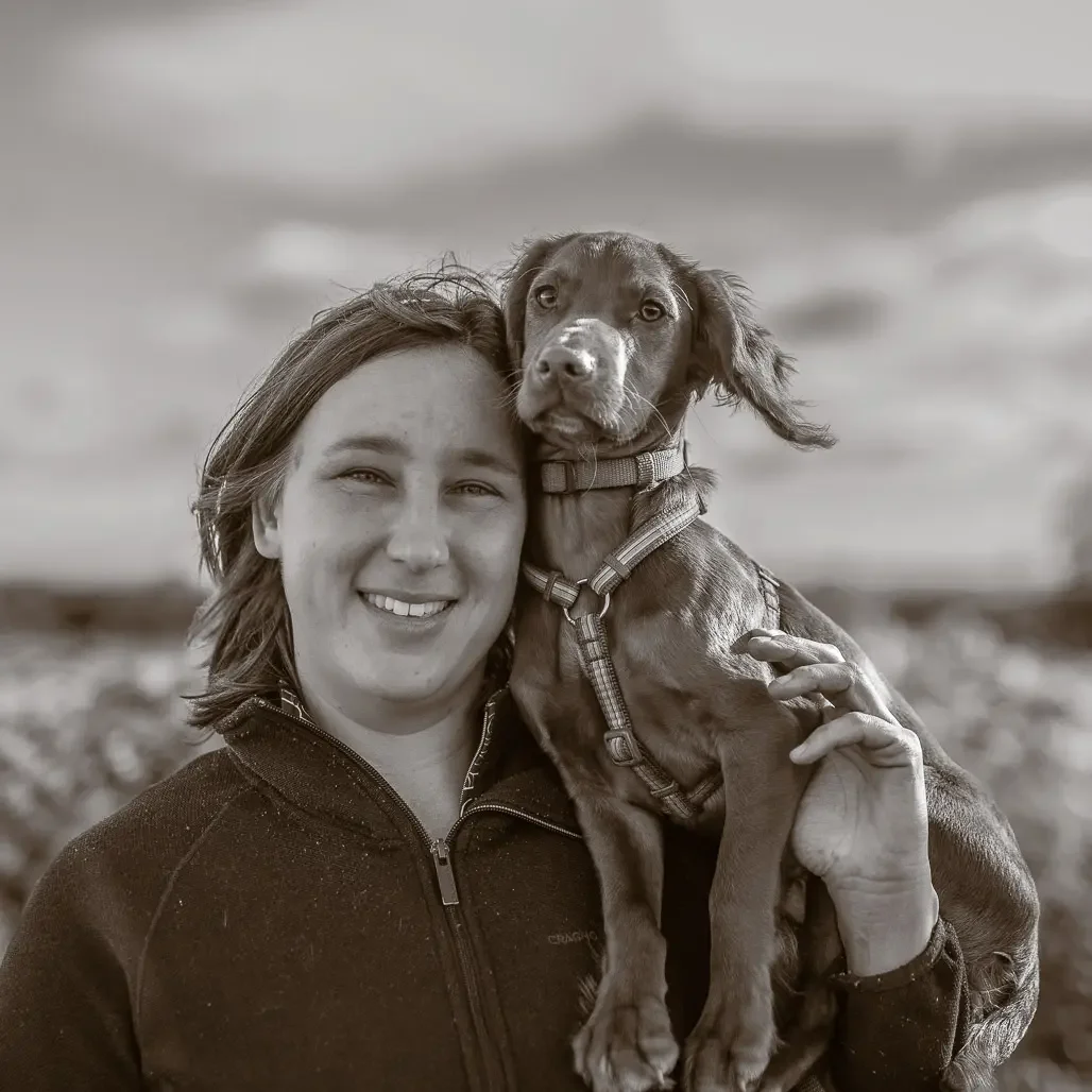 Kim from 4 Peaceful Paws holding her spaniel — compassionate separation anxiety trainer UK