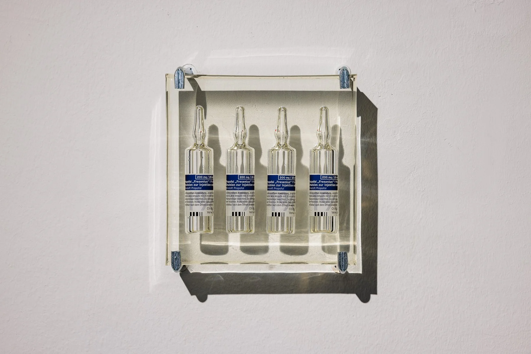 Laura Stoll, 2 hours/Propofol, 2025, empty ampules cast in epoxy resin