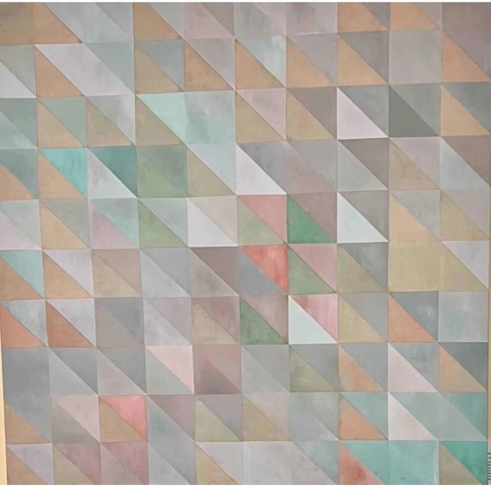 Colorful mosaic tile pattern with small square tiles in various pastel shades including pink, blue, green, beige, and gray arranged in a geometric pattern.
