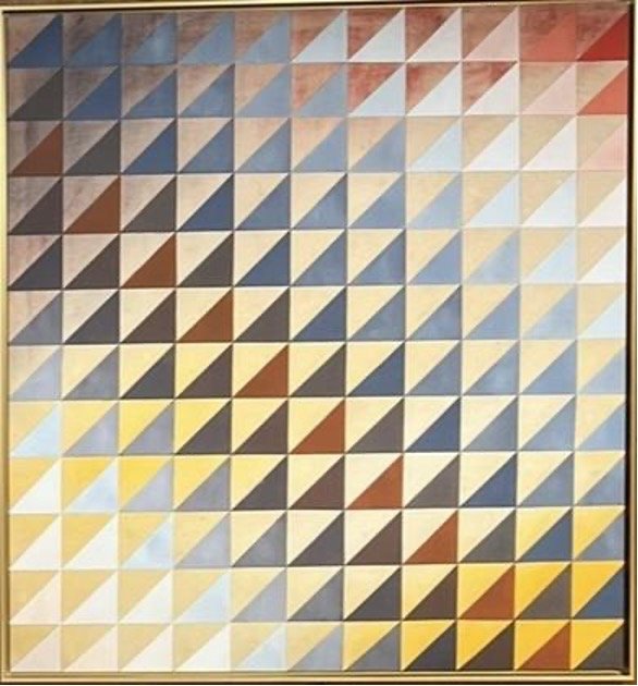 A framed wall art piece consisting of a grid of small squares, each divided diagonally into two triangles in various shades of blue, brown, gray, yellow, and white.