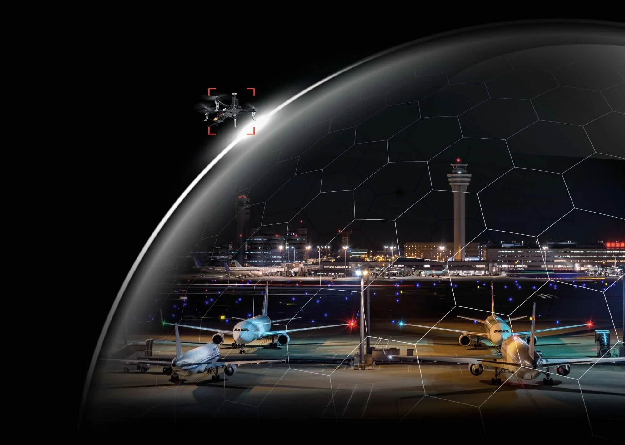 Nighttime view of an airport with airplanes parked on the tarmac, an air traffic control tower, and a distant city skyline. A drone with a red targeting mark is flying nearby, and the image features a digital hexagonal overlay.
