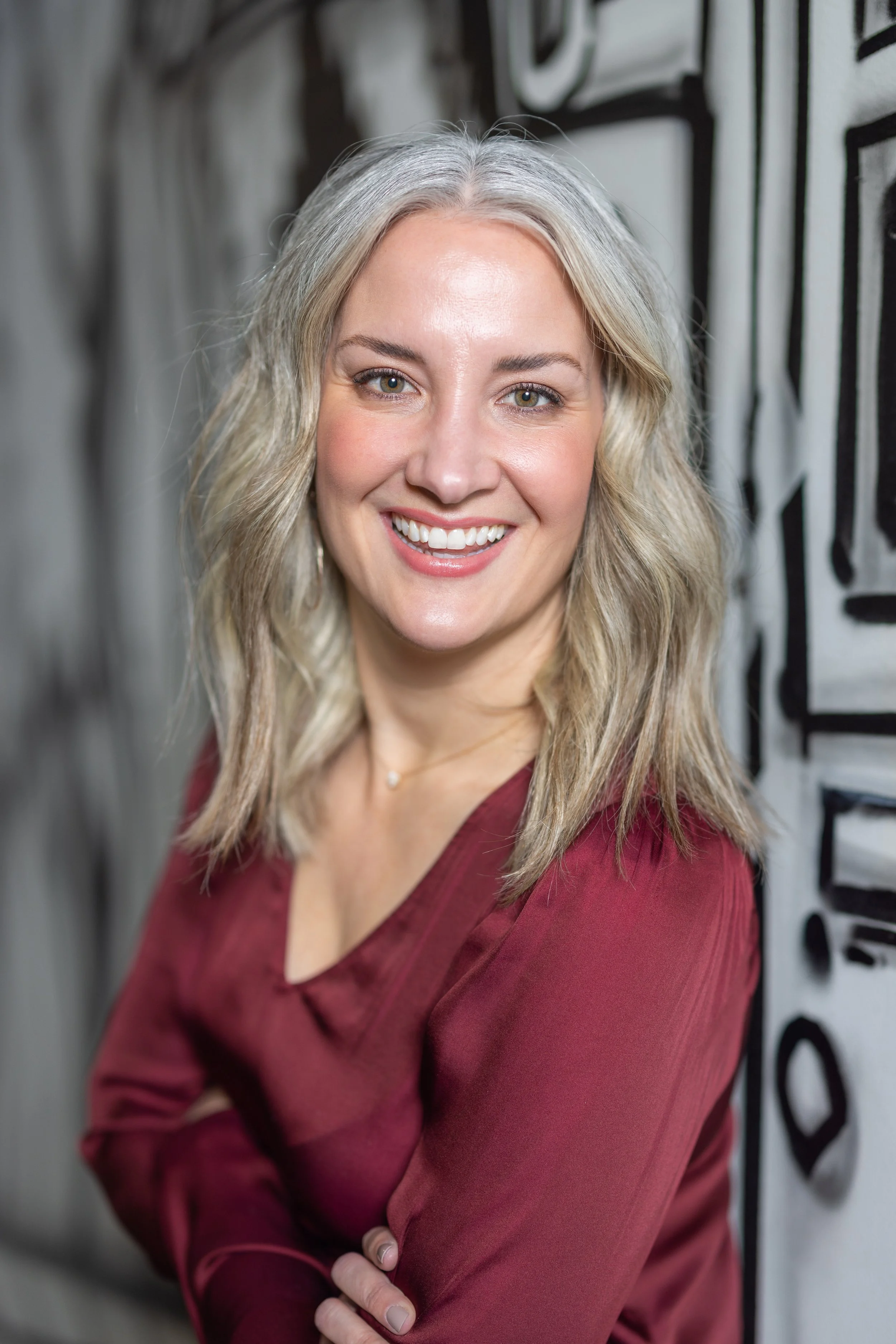 Portrait of Summer Amman, founder of Summer Glen Design, wearing a burgundy blouse.