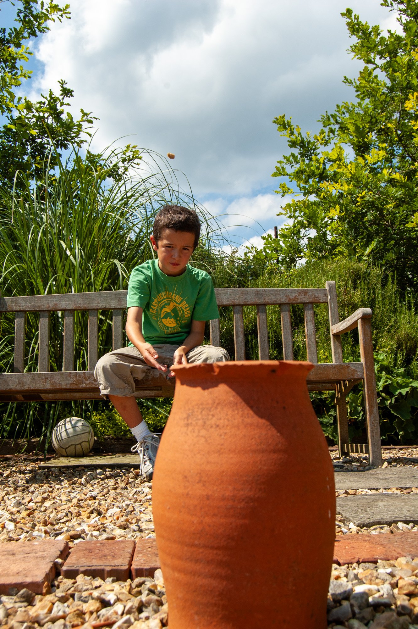 A young boy throwing a stone