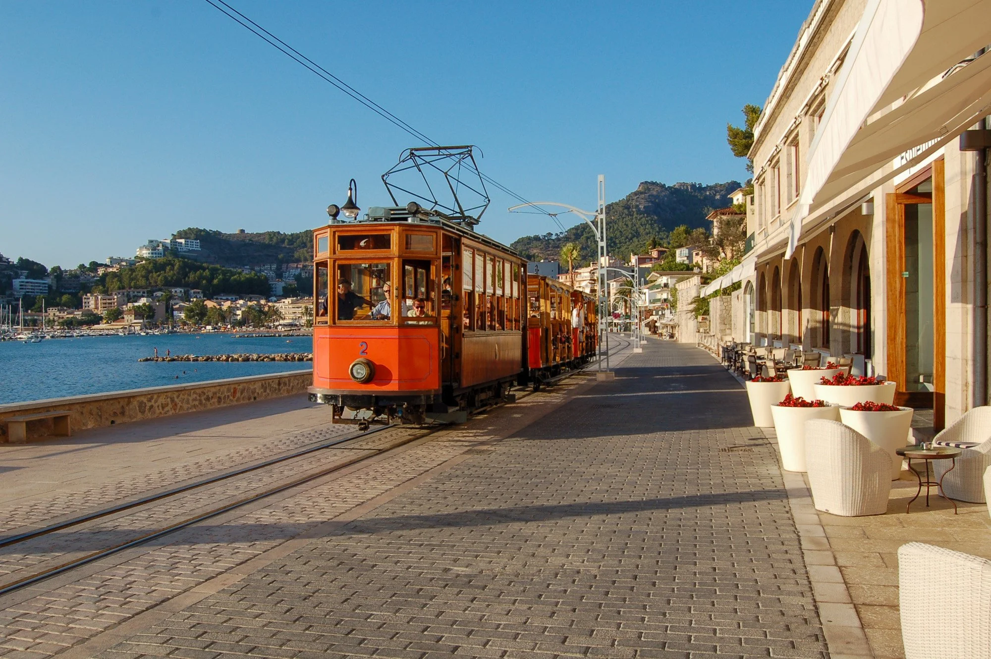 An old tram passes through Port Soller in Mallorca Spain