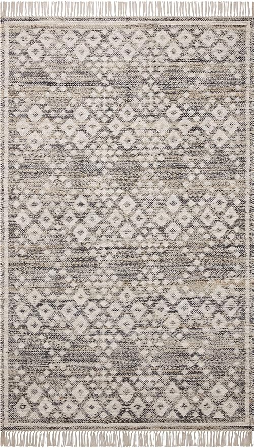 A patterned area rug with geometric diamond and floral motifs in shades of beige, brown, and gray, with fringes on the top and bottom edges.