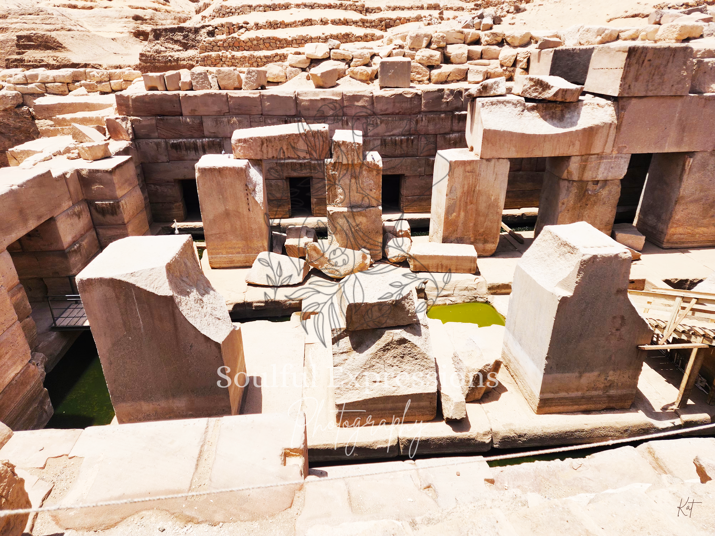 The Temple of Osiris in Egypt with large rectangular blocks and small openings, possibly part of an archaeological site or ancient construction.