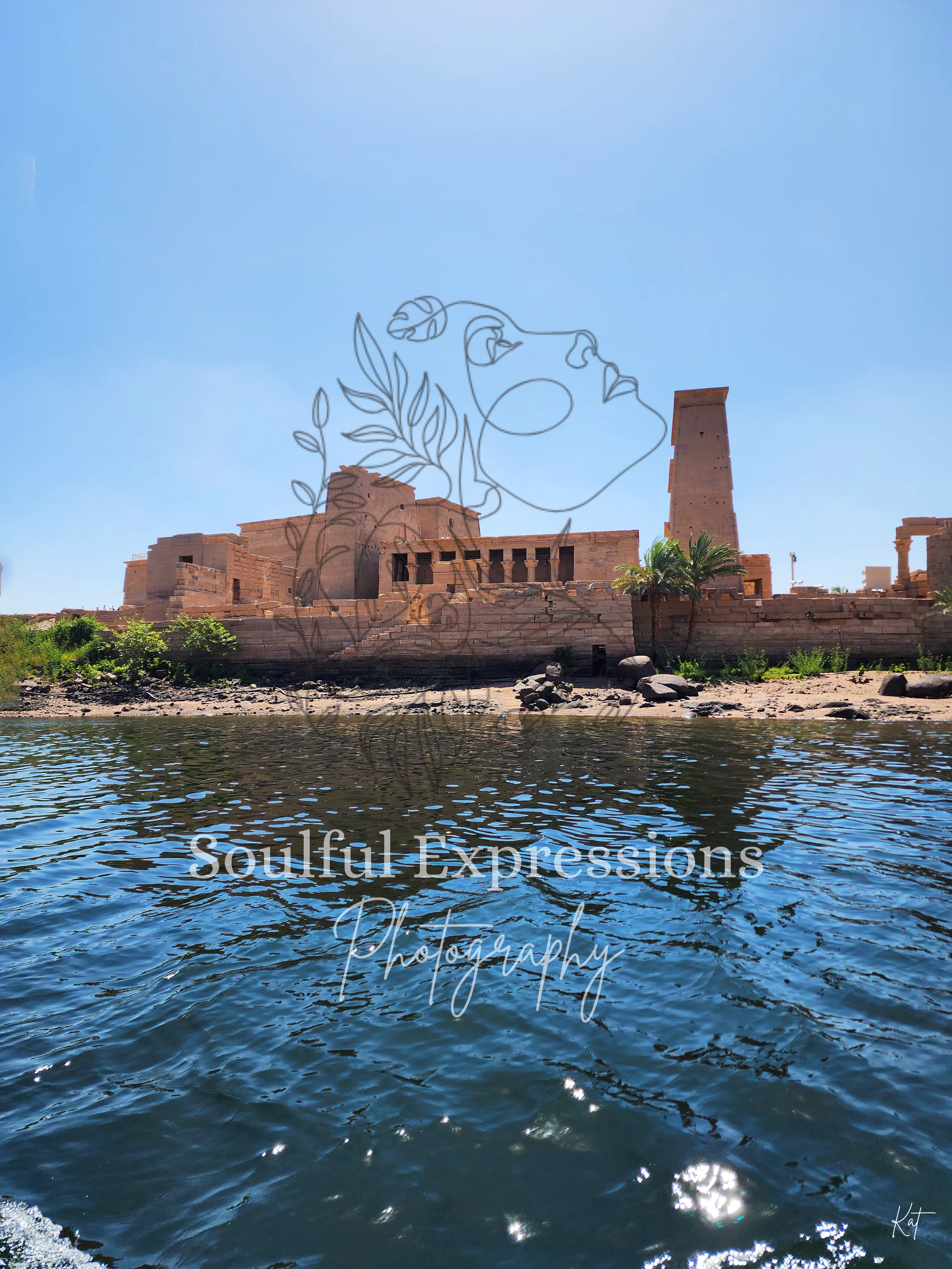 The Isis Temple along the Nile River under a clear blue sky.