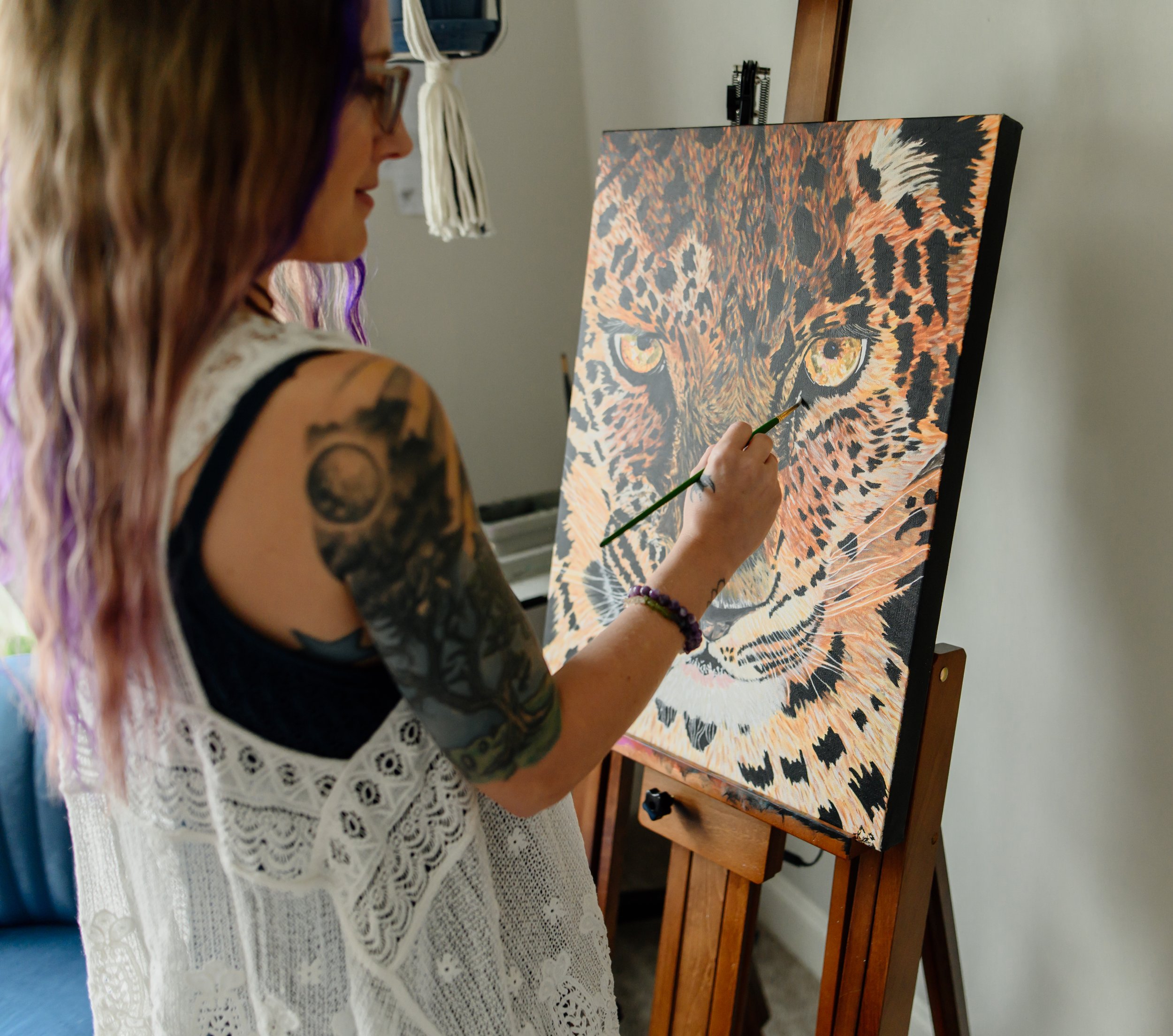 Kat Harrison, showing her love of art while finishing a painting of a Jaguar.