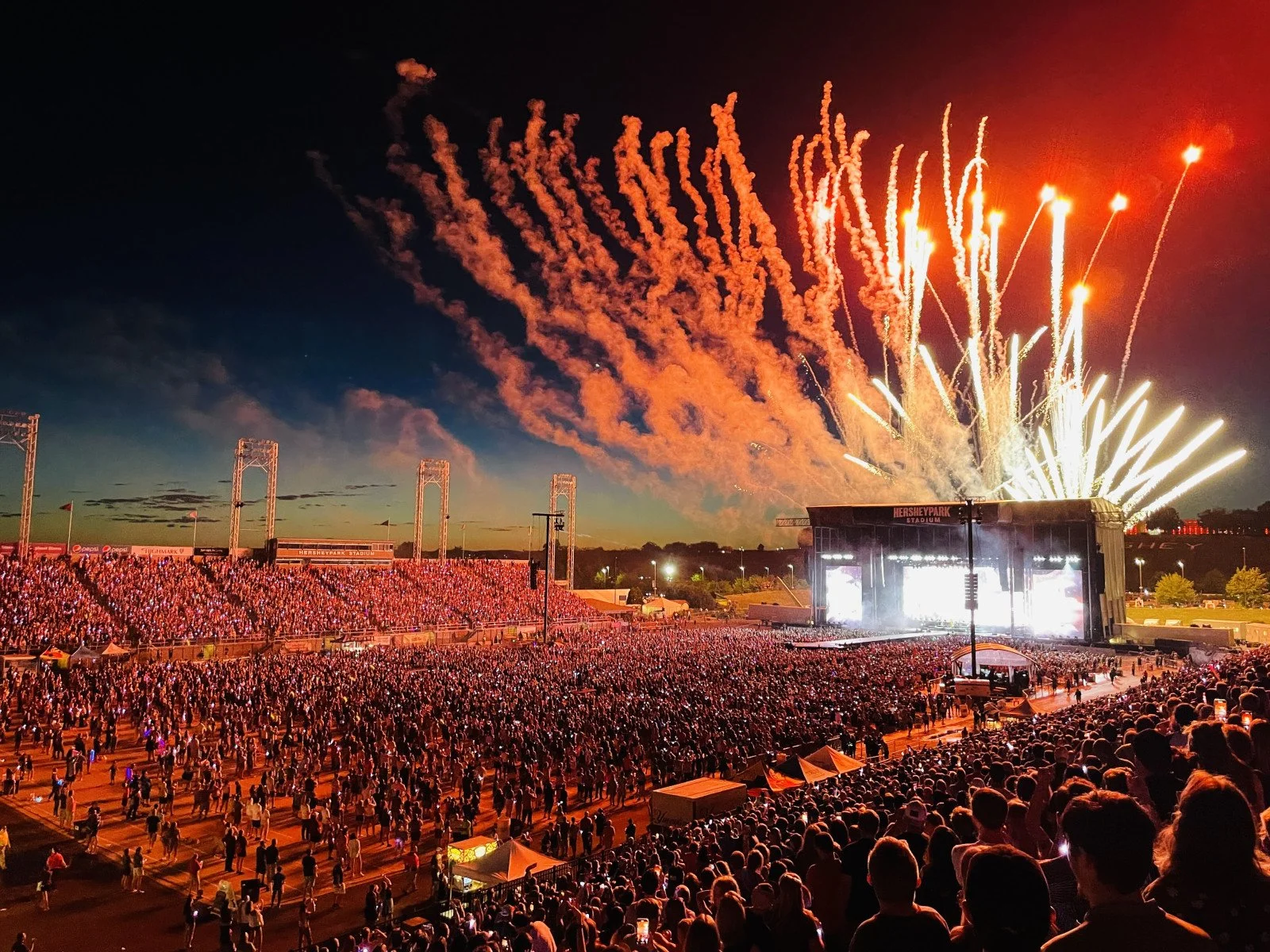Nighttime concert at Hersheypark Stadium with large crowd and fireworks