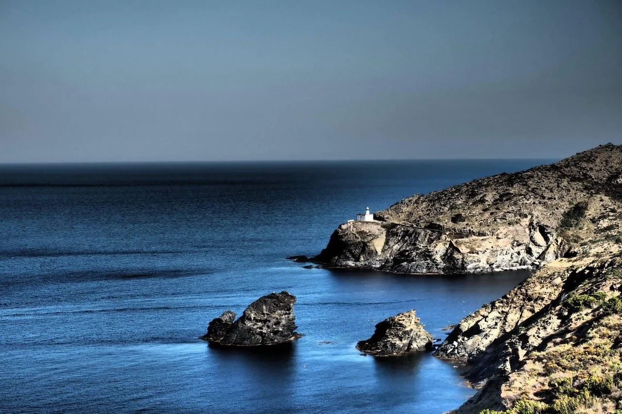 Coastal landscape with rocky shore and lighthouse