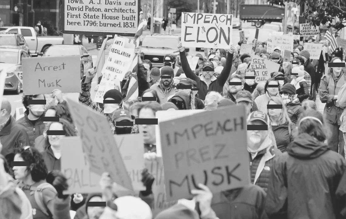 Protest crowd holding signs, including one saying "IMPEACH ELON" and others calling for Musk to be arrested or criticizing him, with many protesters wearing masks.