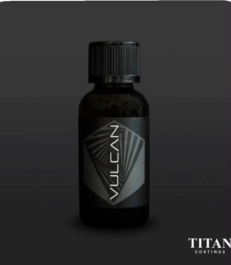 A small dark bottle with a black cap, labeled 'VULCAN' in white text, set against a black background, with the words 'TITAN COATINGS' in the bottom right corner.
