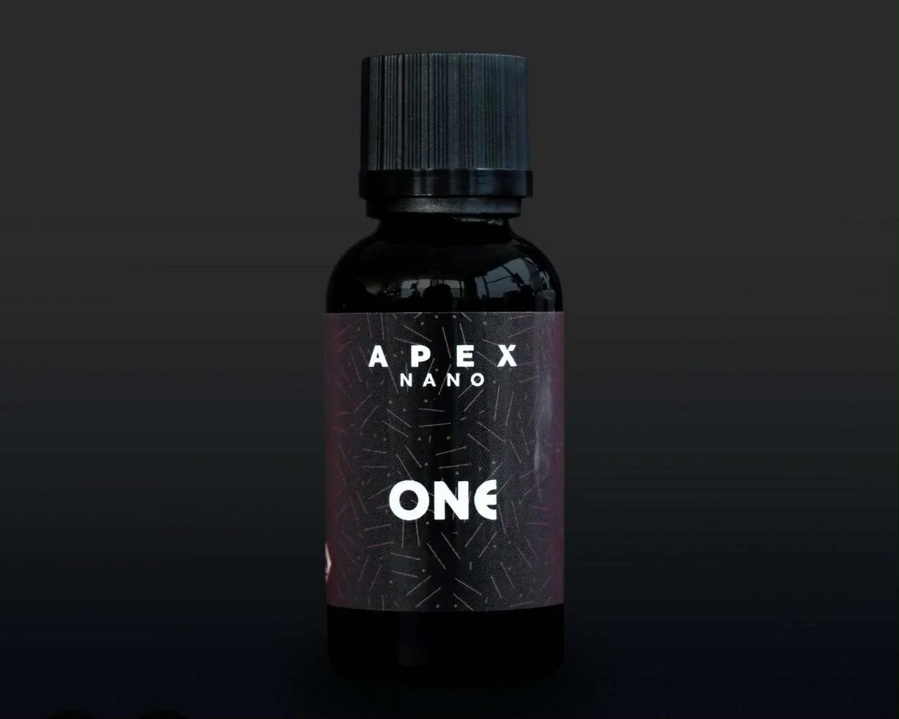 A black bottle with a dark label reading 'APEX NANO ONE' set against a dark background.