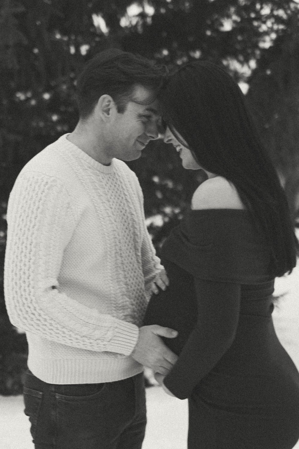 Documentary style black and white photo of a couple, mother is pregnant